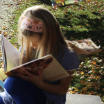 Little girl reading a book